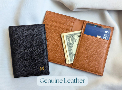Black and brown leather wallets with money and cards on a light gray background