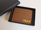 Brown leather cardholder with custom corporate logo branding in gold on a white background