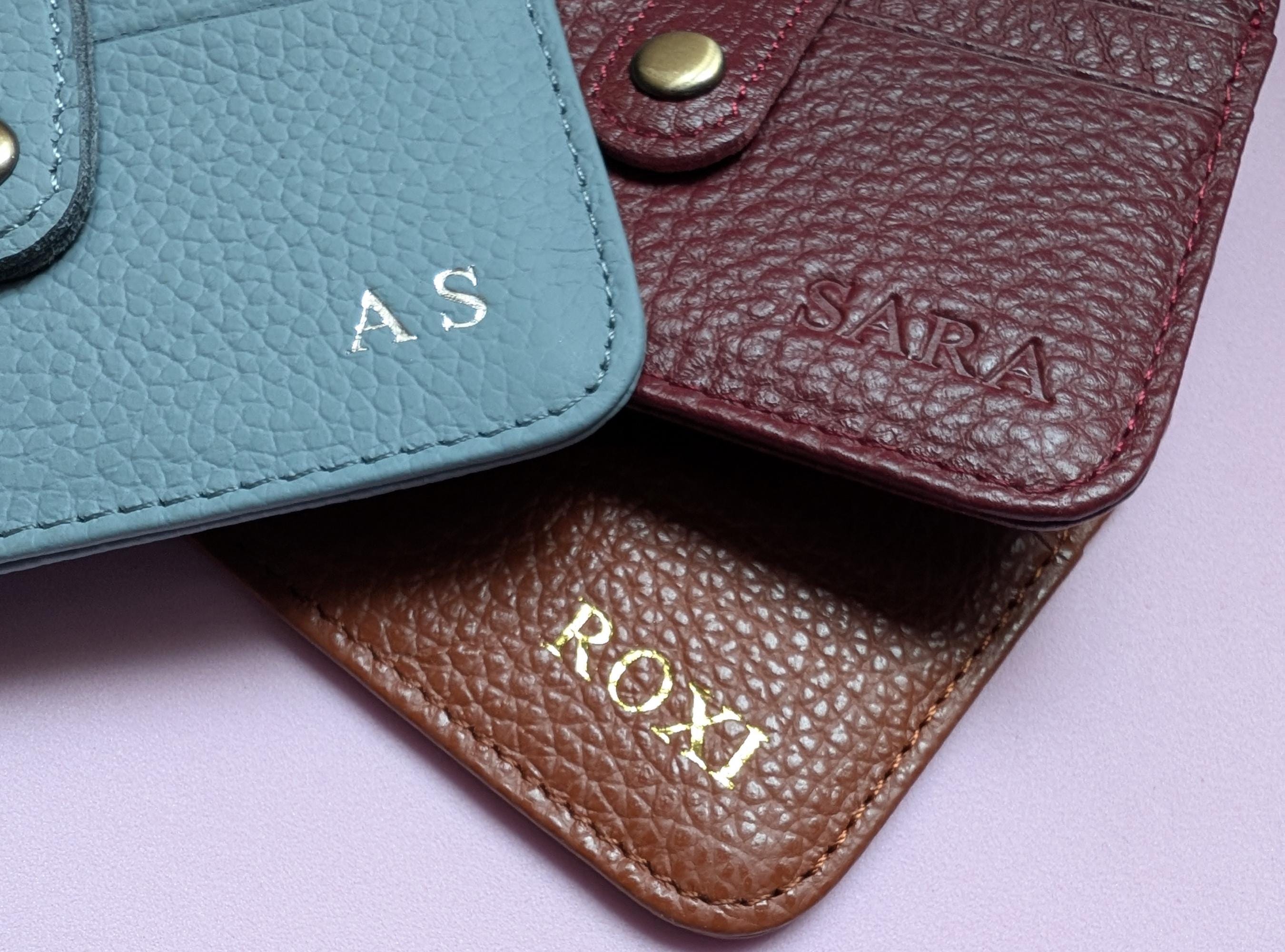 Three leather pouches with custom initials.