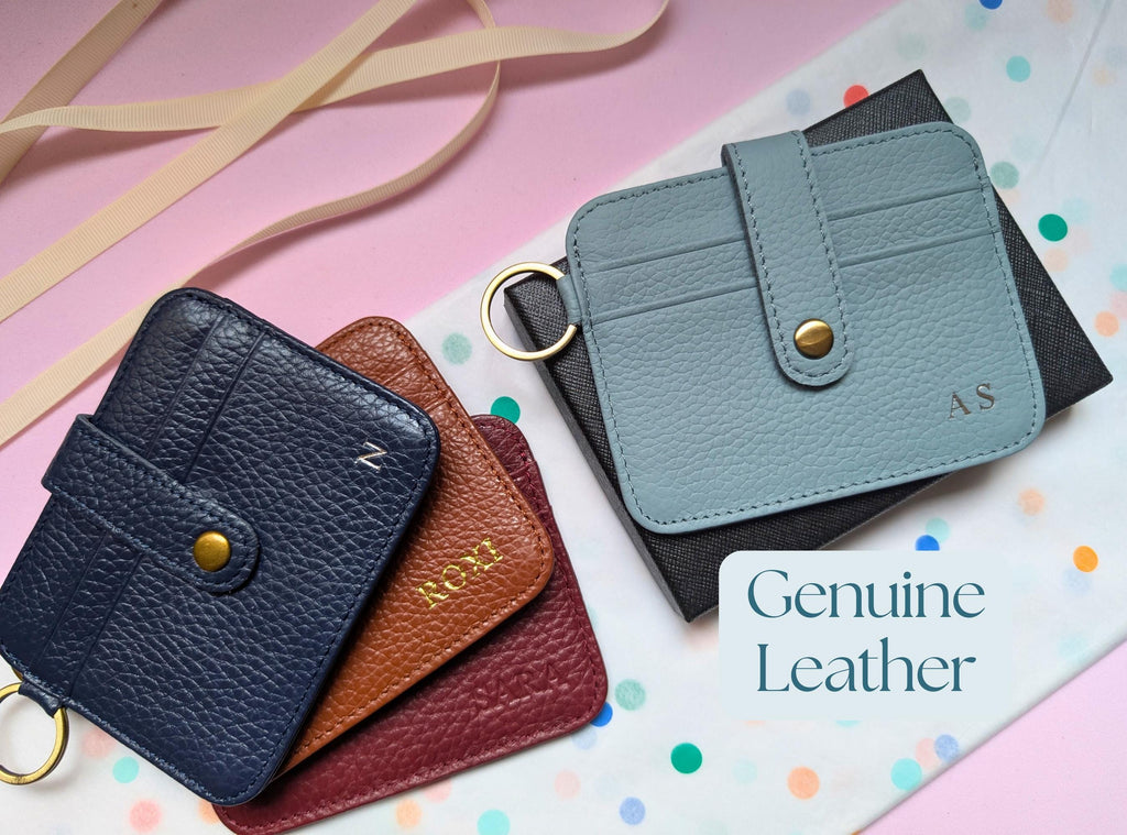 Four leather wallets in different colors on a colorful background with 'Genuine Leather' text.