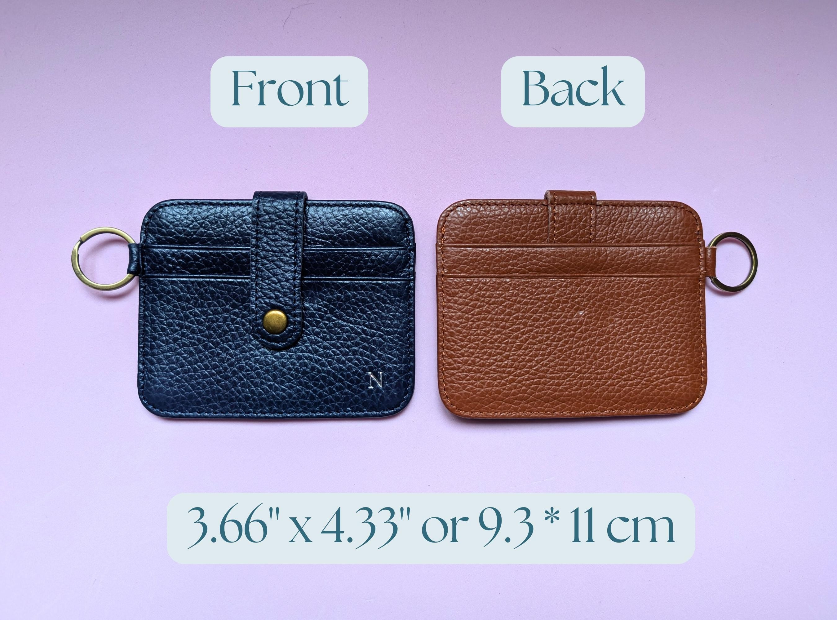Two leather card holders, one blue and one brown, on a purple background with text indicating dimensions.