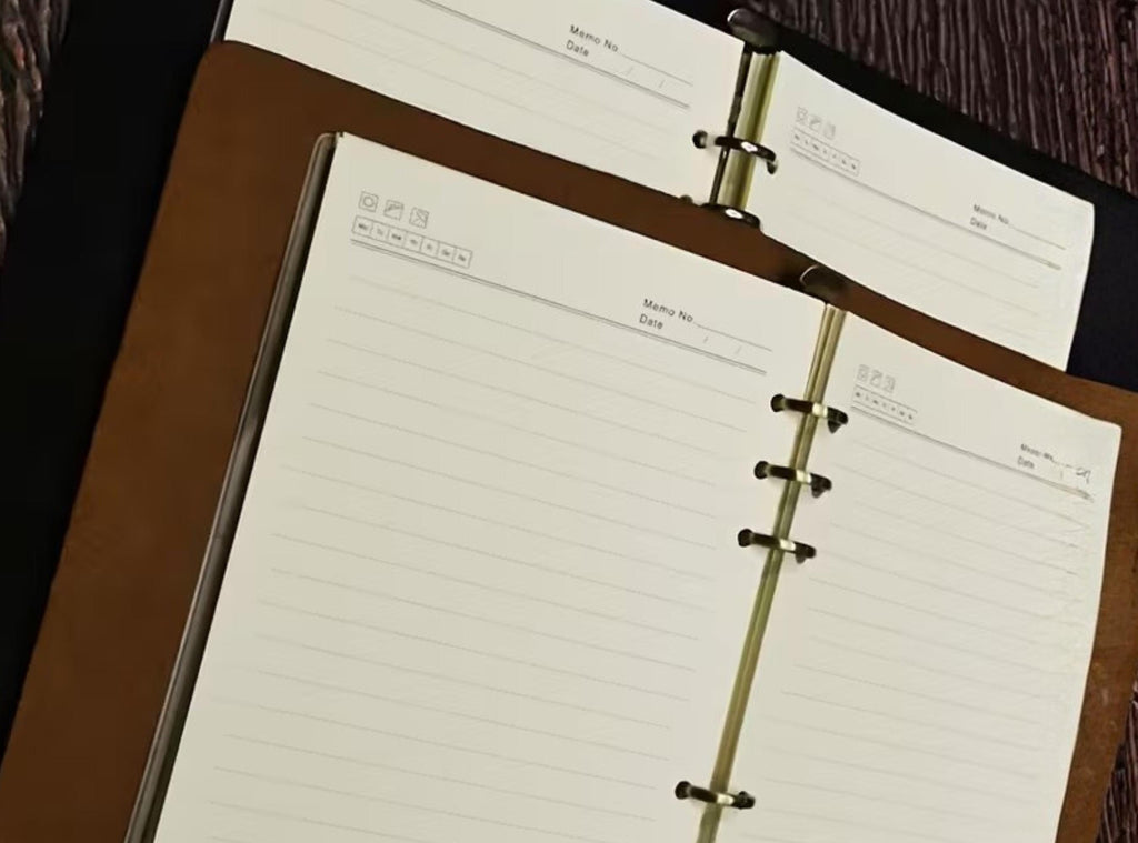 Open ring-bound planner on a wooden surface