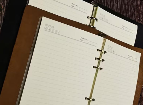 Open ring-bound planner on a wooden surface