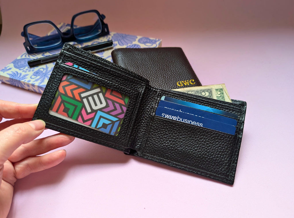 Black wallet with colorful cardholder and money clip on a pink surface