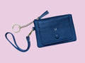 Blue wallet with chain strap on a pink background