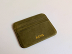 Green cardholder with  custom gold engraving on a white background