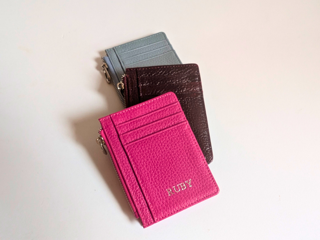 Hot Pink, Wine and Sky Blue card holders on a light background