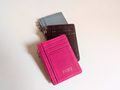 Hot Pink, Wine and Sky Blue card holders on a light background