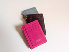 Hot Pink, Wine and Sky Blue card holders on a light background
